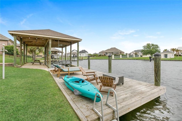 view of dock featuring a yard and a water view