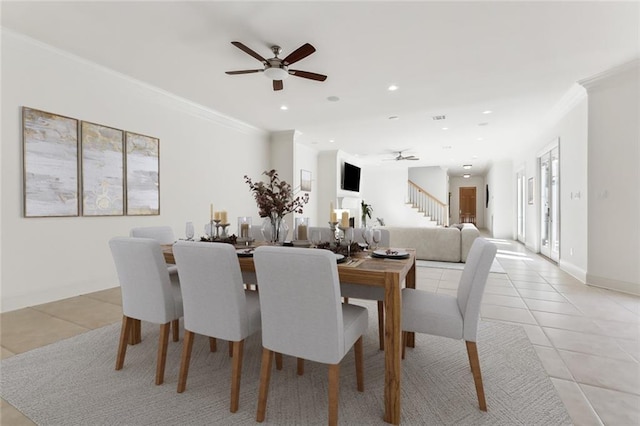 dining room with ornamental molding, light tile patterned flooring, and ceiling fan