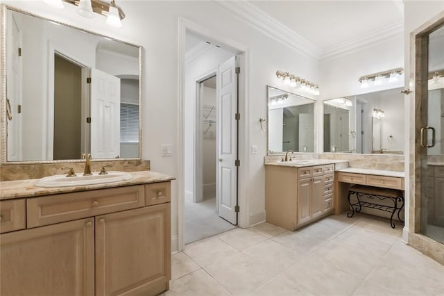 bathroom with vanity, ornamental molding, a shower with shower door, and tile patterned floors