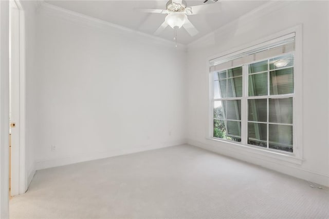 spare room featuring ornamental molding, light carpet, and ceiling fan