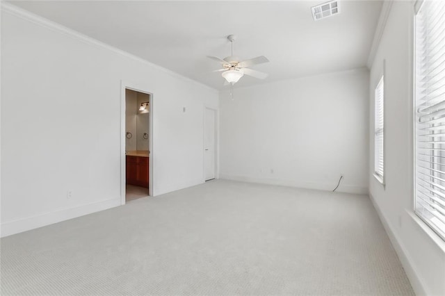 carpeted empty room with crown molding, plenty of natural light, and ceiling fan