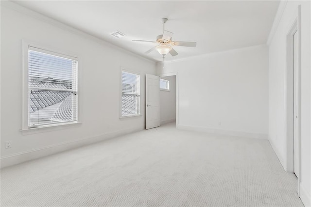 carpeted empty room with ornamental molding and ceiling fan