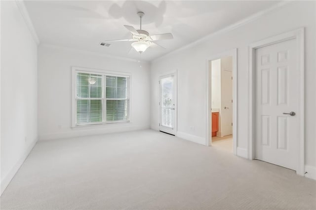 carpeted spare room featuring ceiling fan and crown molding