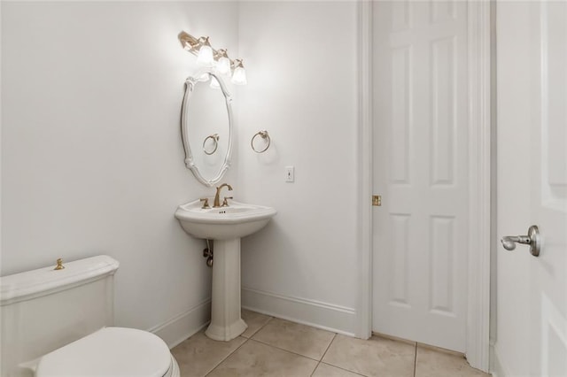 bathroom with toilet and tile patterned floors