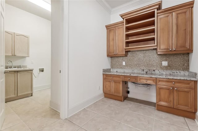 kitchen with decorative backsplash, light stone counters, and light tile patterned floors