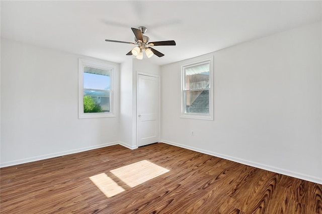 unfurnished room featuring ceiling fan, a healthy amount of sunlight, and hardwood / wood-style floors