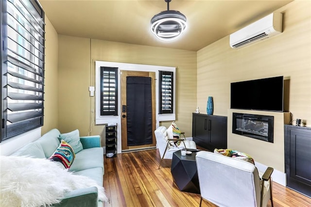 living room with hardwood / wood-style floors and a wall mounted AC