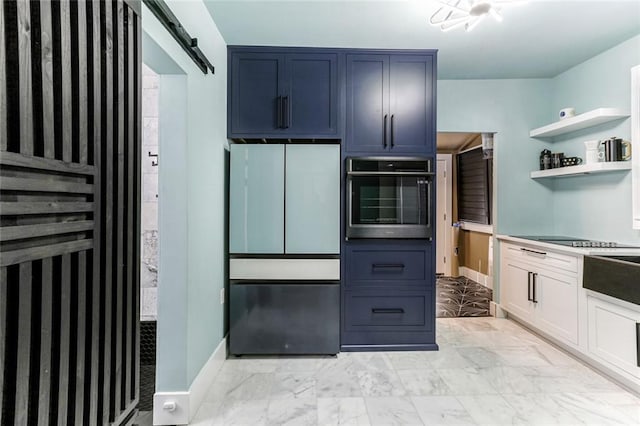 kitchen featuring white cabinetry, stainless steel appliances, a barn door, and blue cabinets