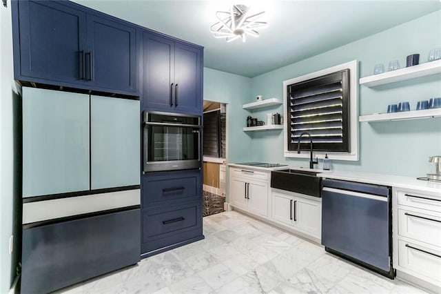 kitchen featuring blue cabinetry, white cabinets, stainless steel appliances, and sink