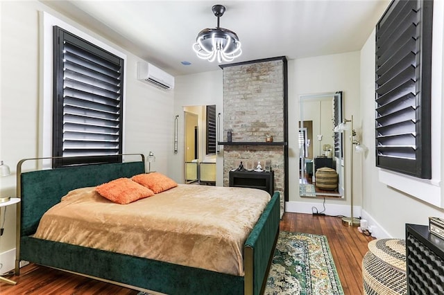 bedroom featuring a wall mounted air conditioner and dark hardwood / wood-style floors