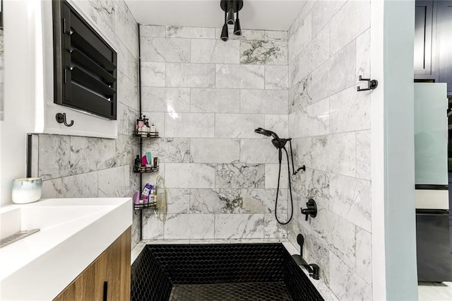 bathroom featuring vanity and a tile shower