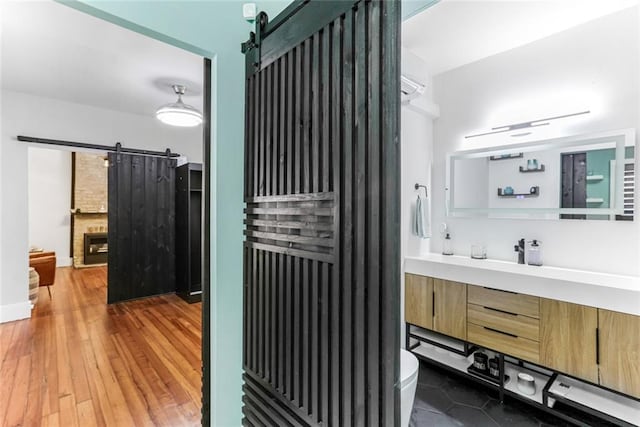 bathroom featuring toilet, vanity, and wood-type flooring