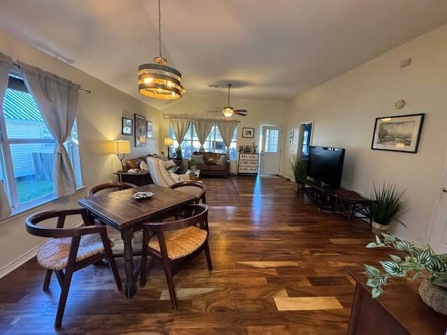 dining area with ceiling fan, lofted ceiling, and dark hardwood / wood-style flooring