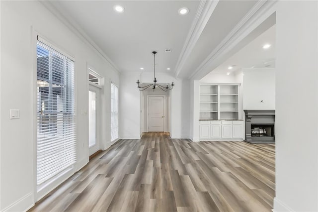 interior space featuring light hardwood / wood-style flooring, a chandelier, and crown molding