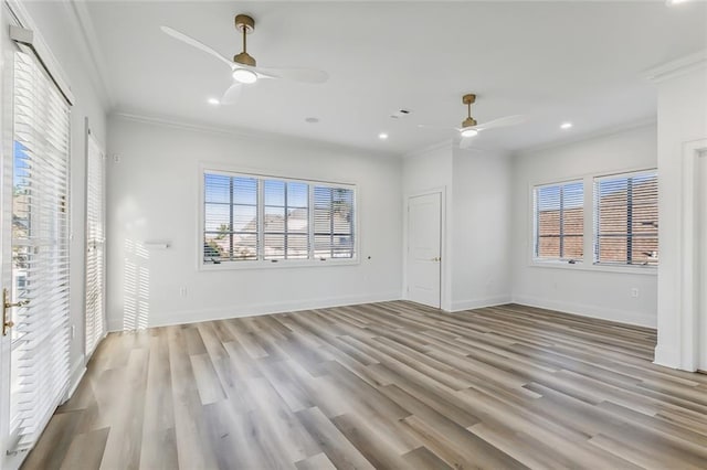 unfurnished living room featuring light hardwood / wood-style flooring, ceiling fan, and crown molding