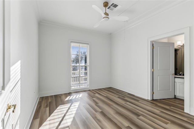 unfurnished room featuring crown molding, hardwood / wood-style flooring, sink, and ceiling fan