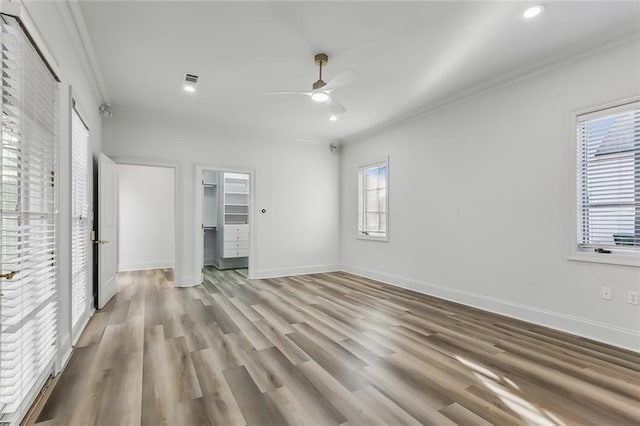 interior space with ornamental molding, light hardwood / wood-style floors, and ceiling fan