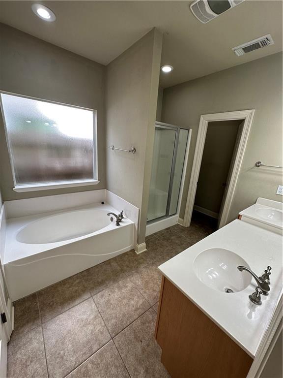 full bath with vanity, a garden tub, visible vents, and a stall shower