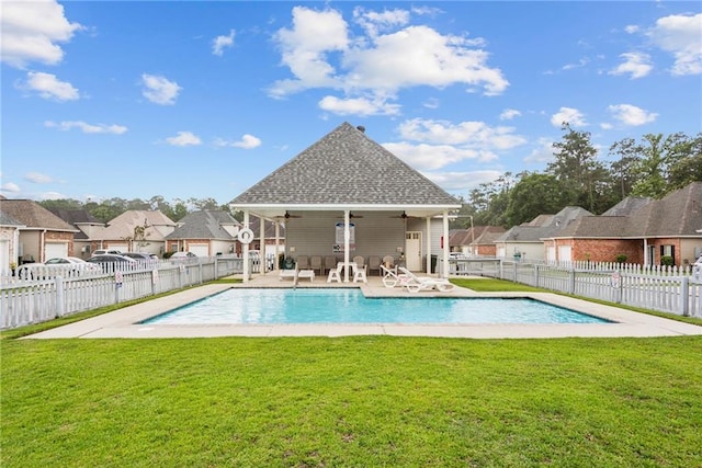 view of pool with a lawn, fence, a fenced in pool, ceiling fan, and a patio area