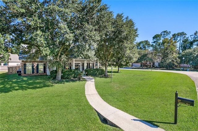 view of property's community featuring a lawn