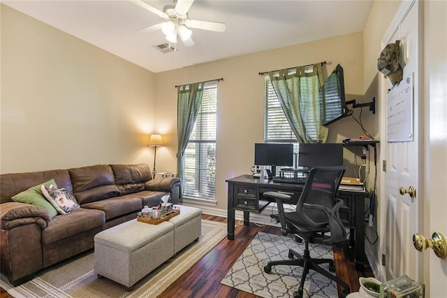 home office with dark wood-type flooring and ceiling fan