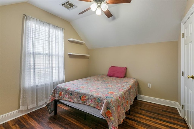 bedroom featuring dark hardwood / wood-style flooring, vaulted ceiling, and ceiling fan