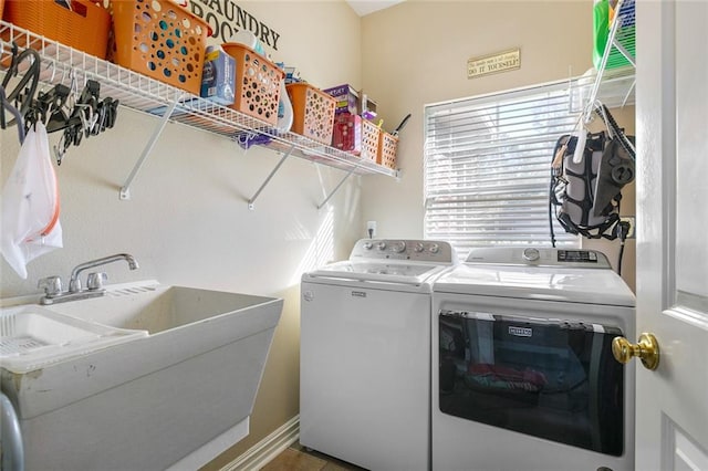 clothes washing area featuring sink and separate washer and dryer