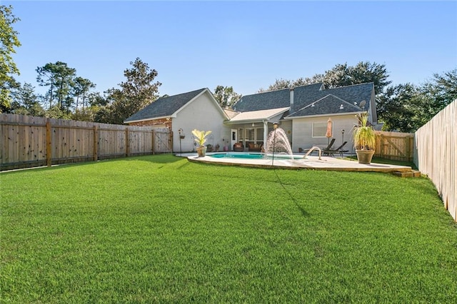 view of yard with a fenced in pool, pool water feature, and a patio