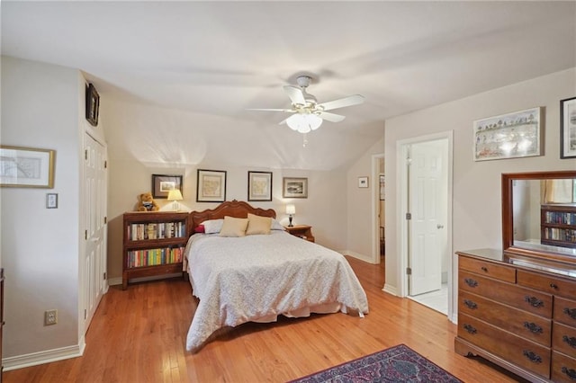 bedroom featuring a closet, hardwood / wood-style flooring, lofted ceiling, and ceiling fan