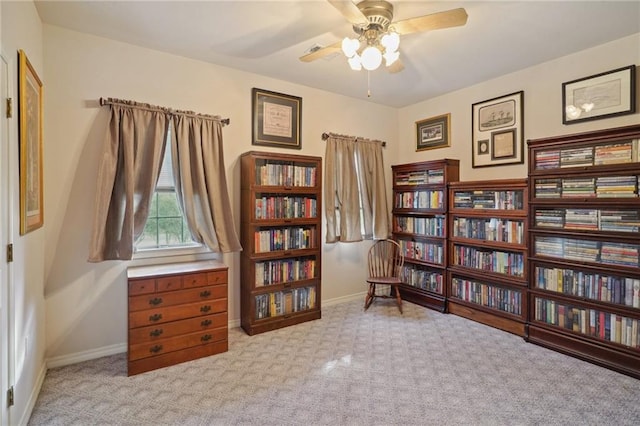 sitting room featuring light colored carpet and ceiling fan