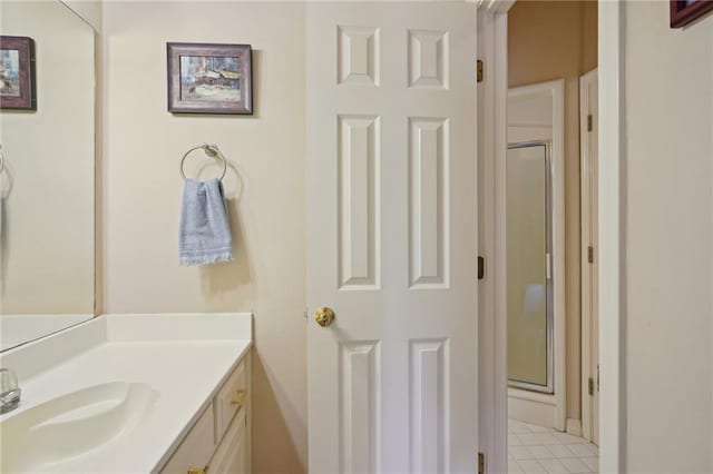 bathroom with vanity and a shower with shower door