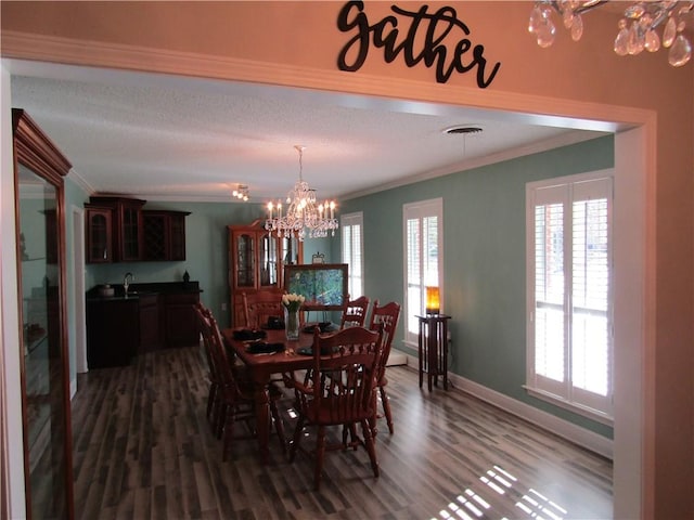 dining area featuring ornamental molding, wood-type flooring, and plenty of natural light