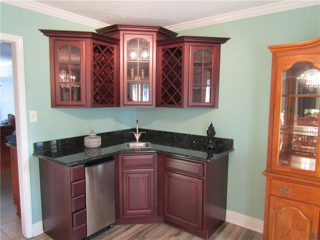 bar featuring dishwasher, a textured ceiling, sink, and ornamental molding