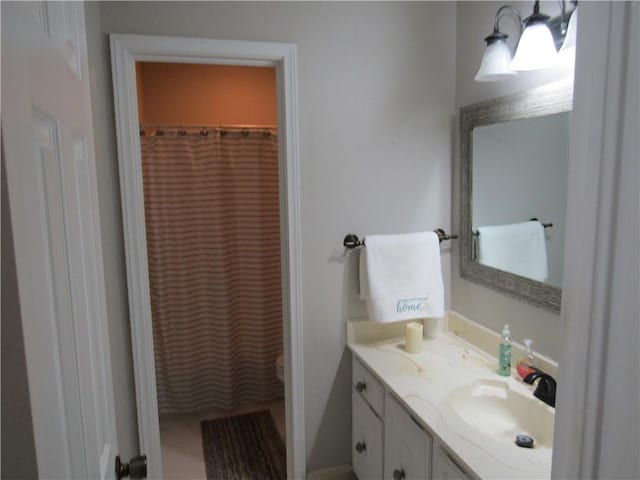 bathroom with vanity, a shower with curtain, and toilet