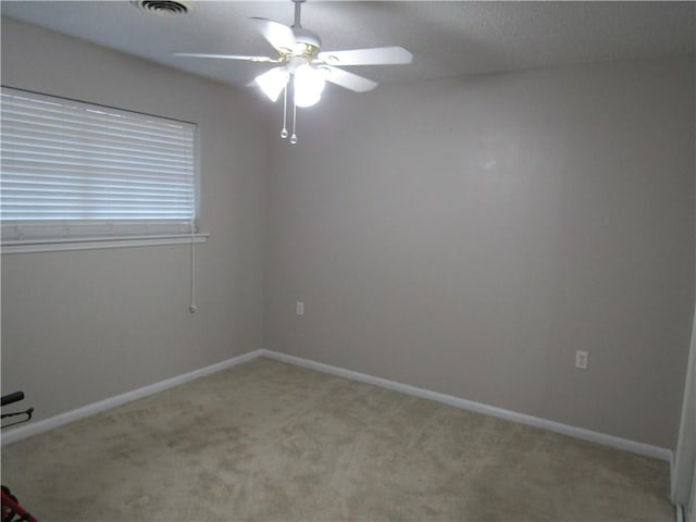 spare room with light carpet and ceiling fan