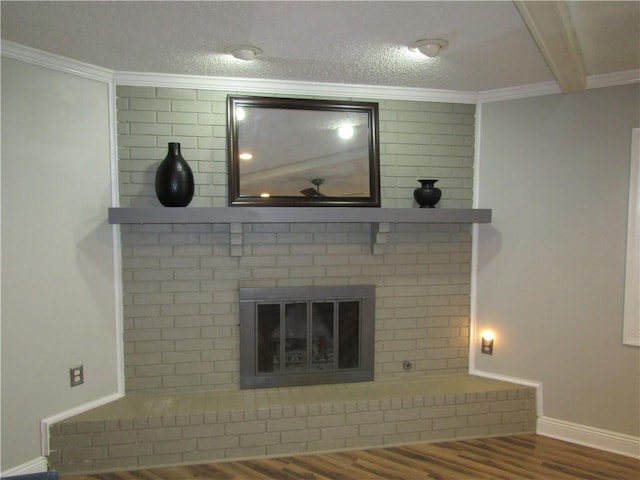 details featuring hardwood / wood-style floors, a fireplace, crown molding, and a textured ceiling