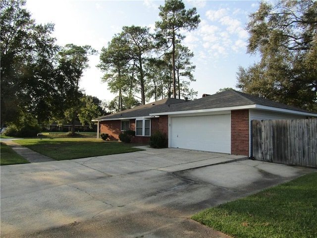 ranch-style home with a front yard and a garage