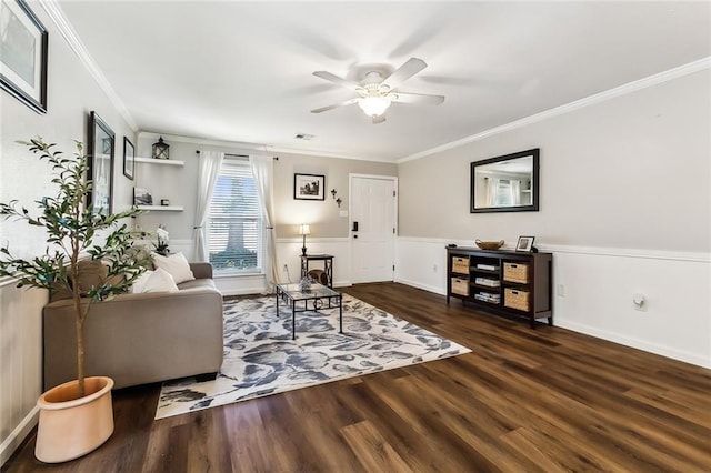 living room with ornamental molding, dark hardwood / wood-style floors, and ceiling fan