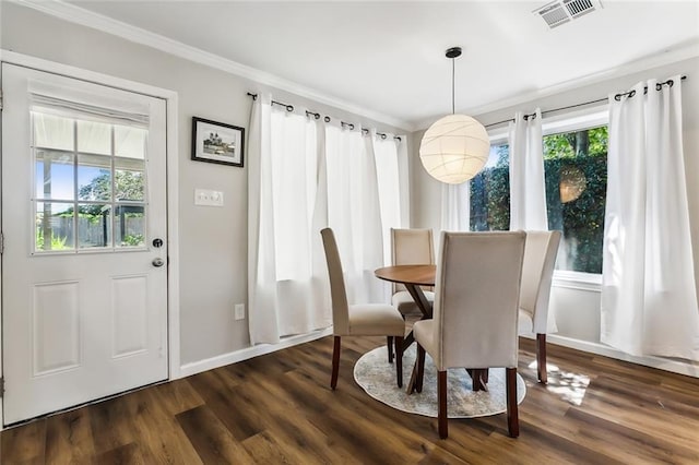 dining area featuring ornamental molding and dark hardwood / wood-style floors