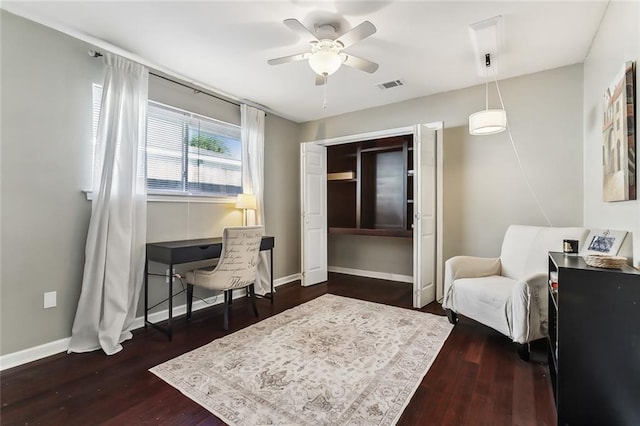 sitting room with dark hardwood / wood-style floors and ceiling fan