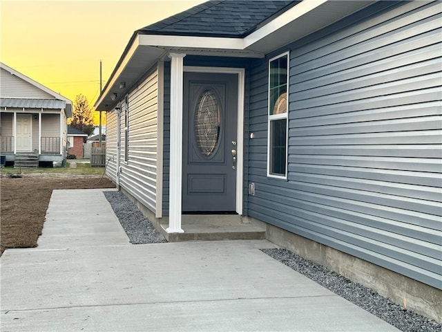 view of exterior entry at dusk