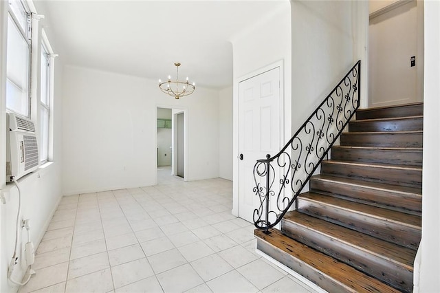 tiled foyer entrance with an inviting chandelier