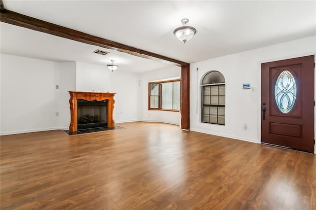 foyer with beam ceiling and hardwood / wood-style floors