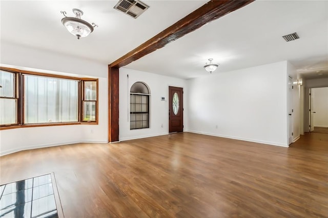 interior space featuring hardwood / wood-style floors and beam ceiling