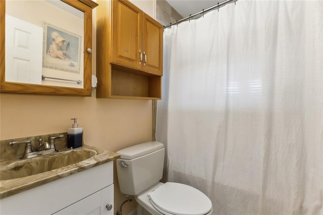 bathroom with toilet, curtained shower, and vanity