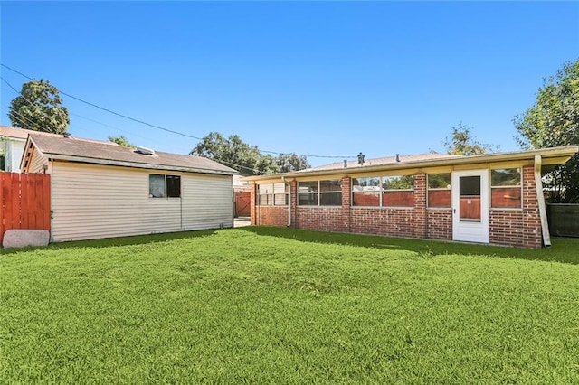 rear view of property featuring a yard