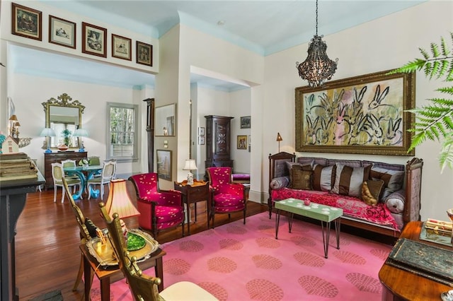 interior space featuring hardwood / wood-style flooring and an inviting chandelier