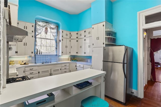 kitchen with white cabinetry, dark hardwood / wood-style flooring, and stainless steel fridge