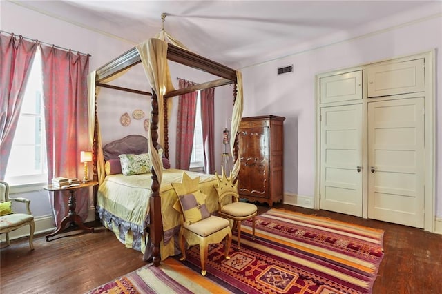 bedroom with a closet and dark hardwood / wood-style flooring