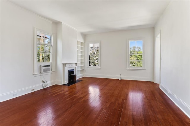 unfurnished living room featuring cooling unit, dark hardwood / wood-style floors, and built in features